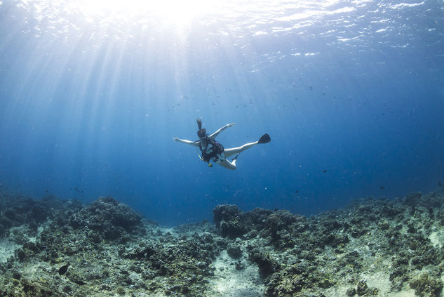 Woman scuba diving in clear blue water