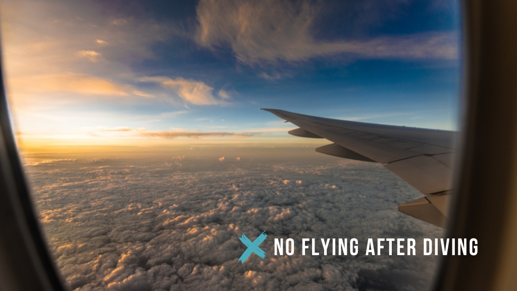 View out of an airplane window of peachy coloured clouds at dusk, with the plane wing visible. Overlaid white text reads "no flying after diving" with a teal cross icon. 