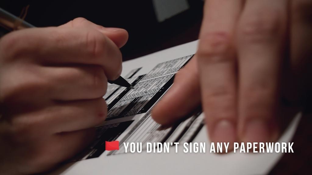 Close up of hands filling out medical paperwork. Overlaid white text reads "You didn't sign any paperwork" with a red flag icon. 
