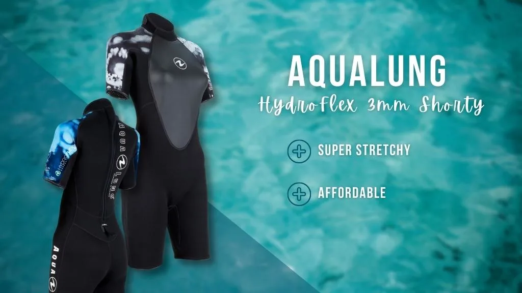 Black women's shorty wetsuit with coral detailing on the short arms, over a faded ocean background. Overlaid white text summarises the benefits of the wetsuit detailed in the article. 