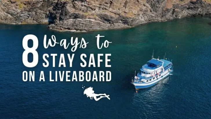 A large scuba liveaboard pictured from above, in deep turquoise water with rocky terrain nearby. Overlaid white text reads "8 ways to stay safe on a liveaboard"