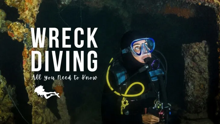 A woman scuba dives inside a wreck. She is wearing a blue mask and looking away from the camera. Overlaid white text reads "wreck diving - all you need to know".