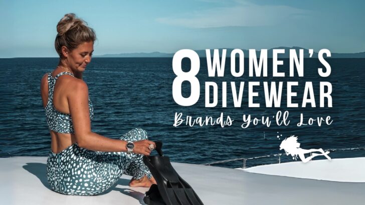 Charlotte sits on top of a large dive boat wearing pieces from the Girls that Scuba whale shark divewear collection. She is smiling and looking at the black fins she's picking up. Overlaid white text reads "8 Women's Divewear Brands You'll Love"